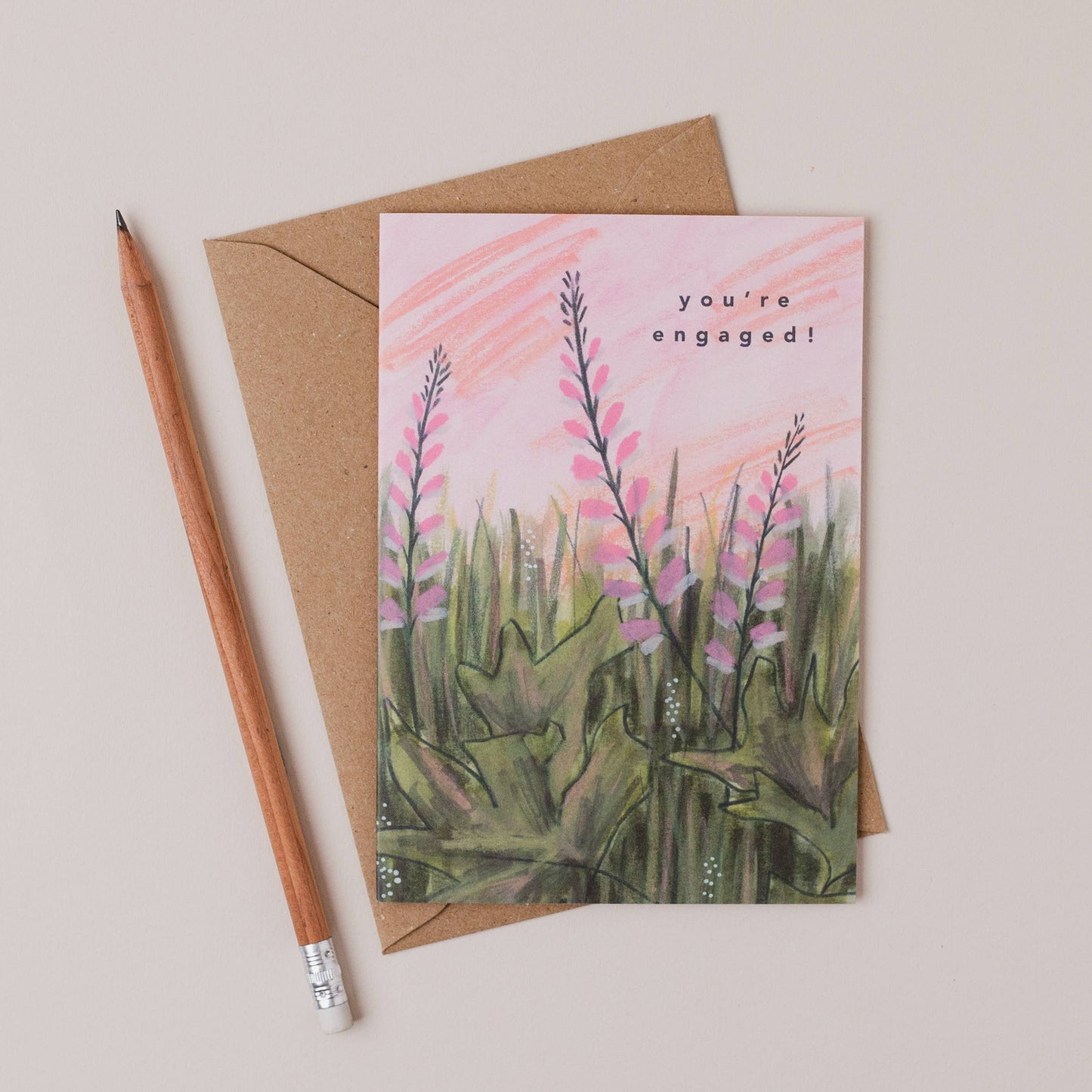 Luxury A6 engagement card with 'you're engaged!' text and pink flower illustration, blank inside, printed on 350gsm UK card