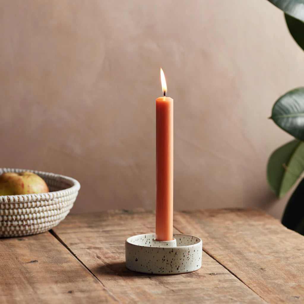 St Eval ceramic speckled candle holder with a central cylindrical opening to hold a dinner candle.