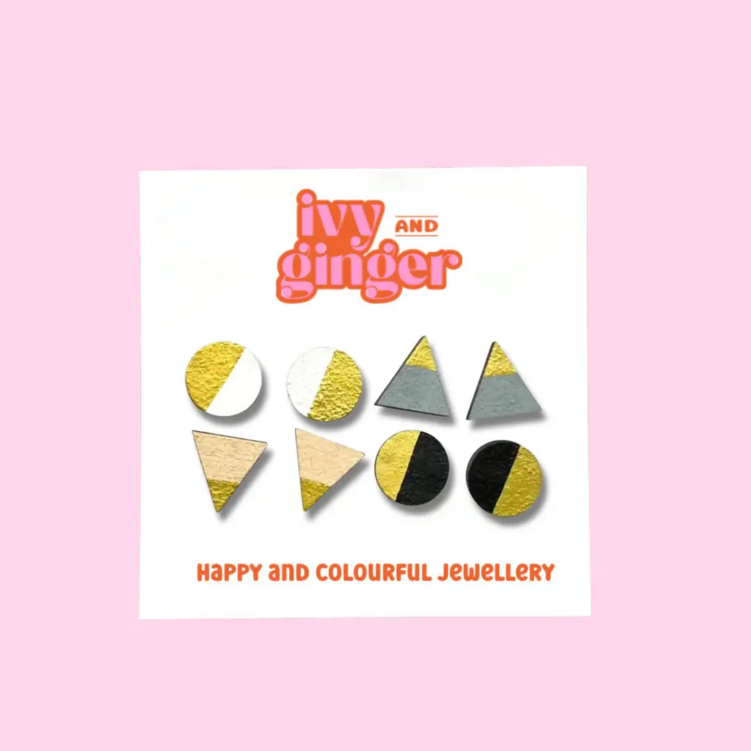 Set of four monochrome and gold stud earrings in triangle and circle shapes, handmade from FSC wood with surgical steel posts.