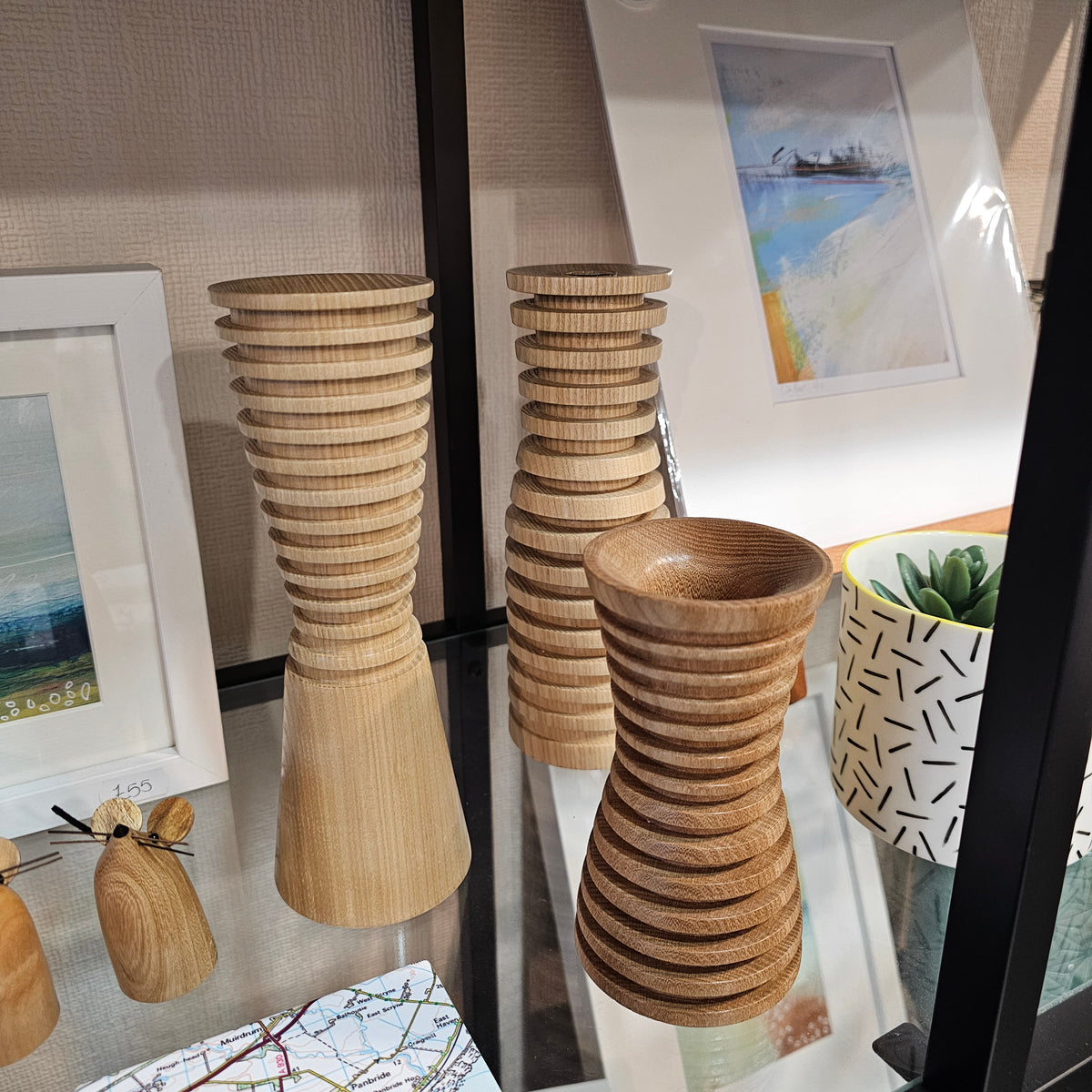 A collection of unique, handcrafted wooden vases in different styles (conical, ribbed short, ribbed tall), showing the natural wood grain and high-quality finish.