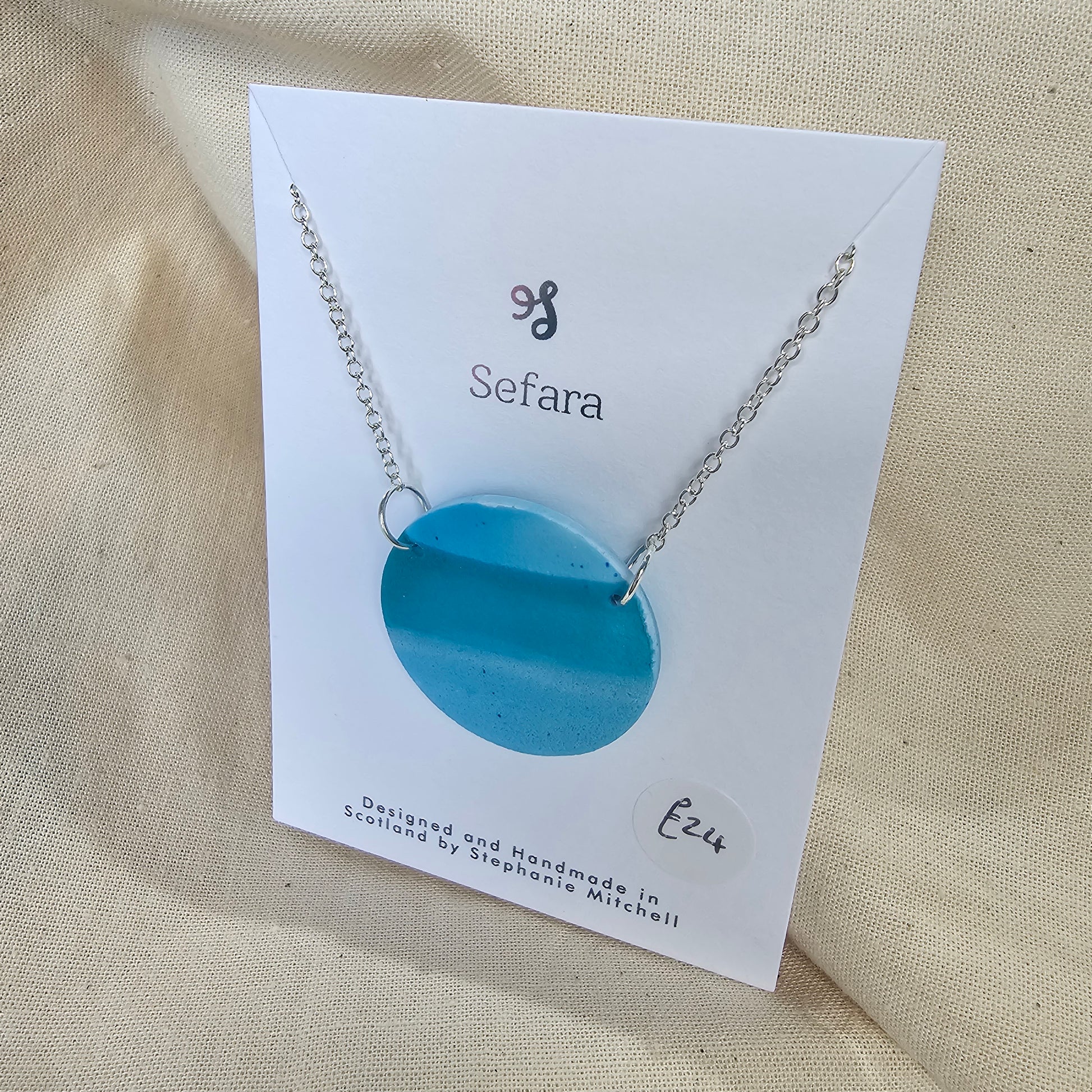 Large handmade blue polymer clay pendant on 18-inch silver chain by Sefara Jewellery. Nautical design.