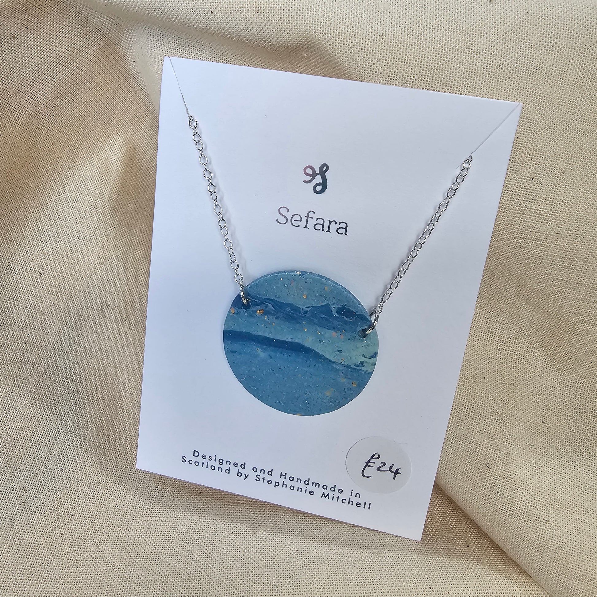 Large handmade blue polymer clay pendant on 18-inch silver chain by Sefara Jewellery. Nautical design.