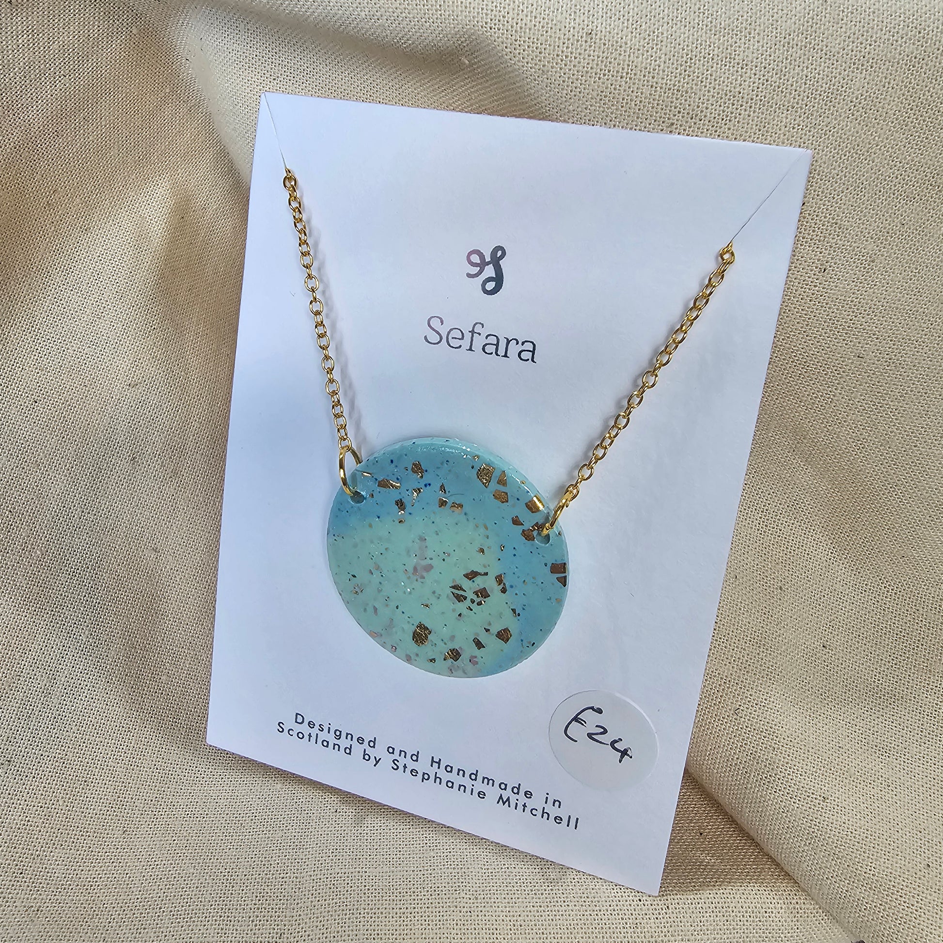 Large handmade aqua polymer clay pendant on 18-inch gold plated chain by Sefara Jewellery. Gold leaf design.
