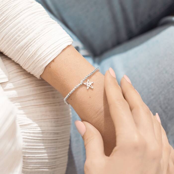 A silver plated beaded bracelet with a star charm