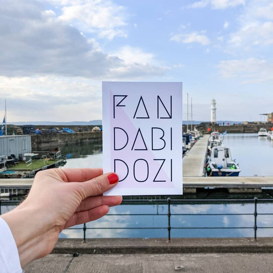 A vertically folded greeting card with the Scottish phrase "Fandabidozi" in a modern, hand-designed style.