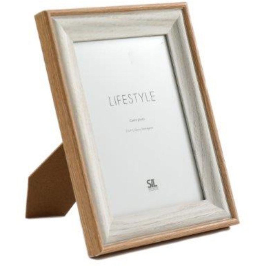 A wooden photo frame with a visible, textured natural edge, finished in a neutral colour palette