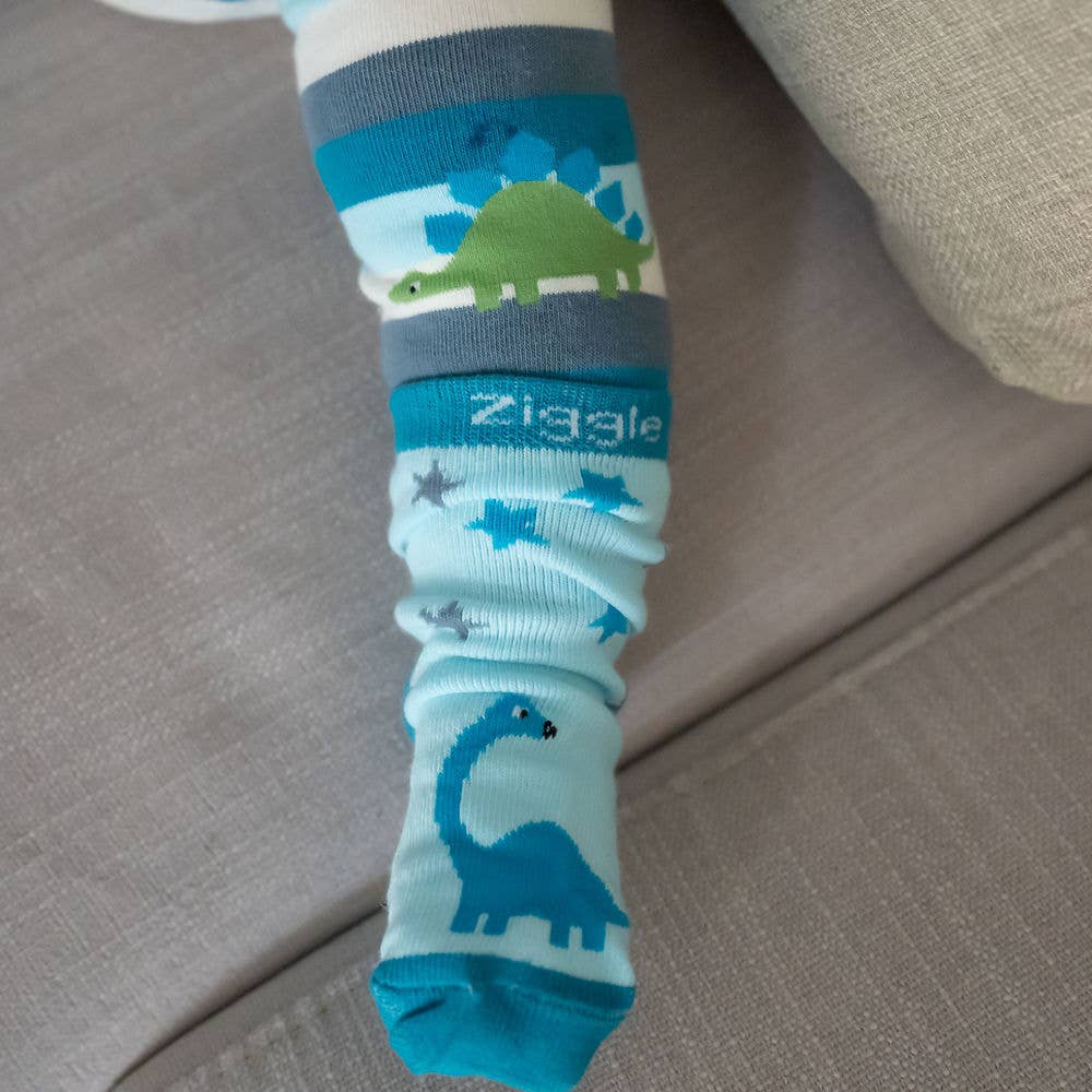 Baby feet wearing cotton baby socks with dinosaur design, anti-slip soles and ribbed cuffs