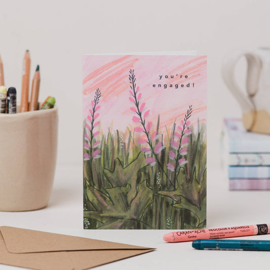 Luxury A6 engagement card with 'you're engaged!' text and pink flower illustration, blank inside, printed on 350gsm UK card