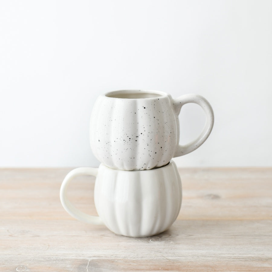 Two white + speckled ceramic pumpkin-shaped mug, ideal for autumn drinks.