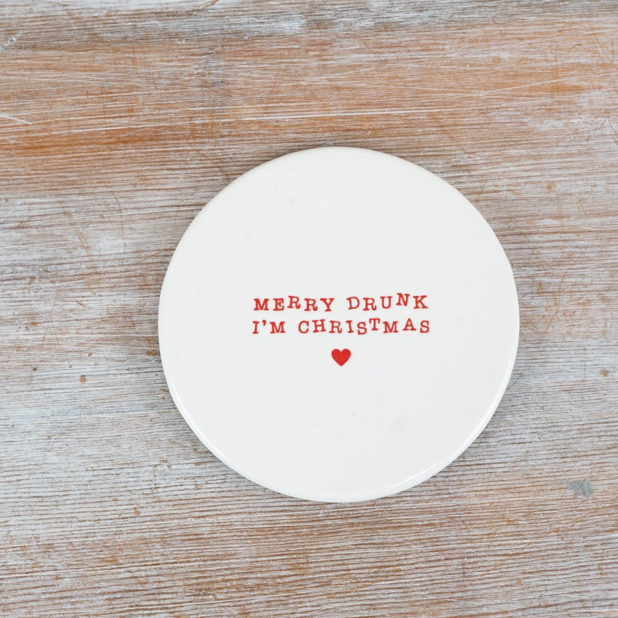 Simple white ceramic Christmas coaster, each with a different festive phrase and a small red heart.