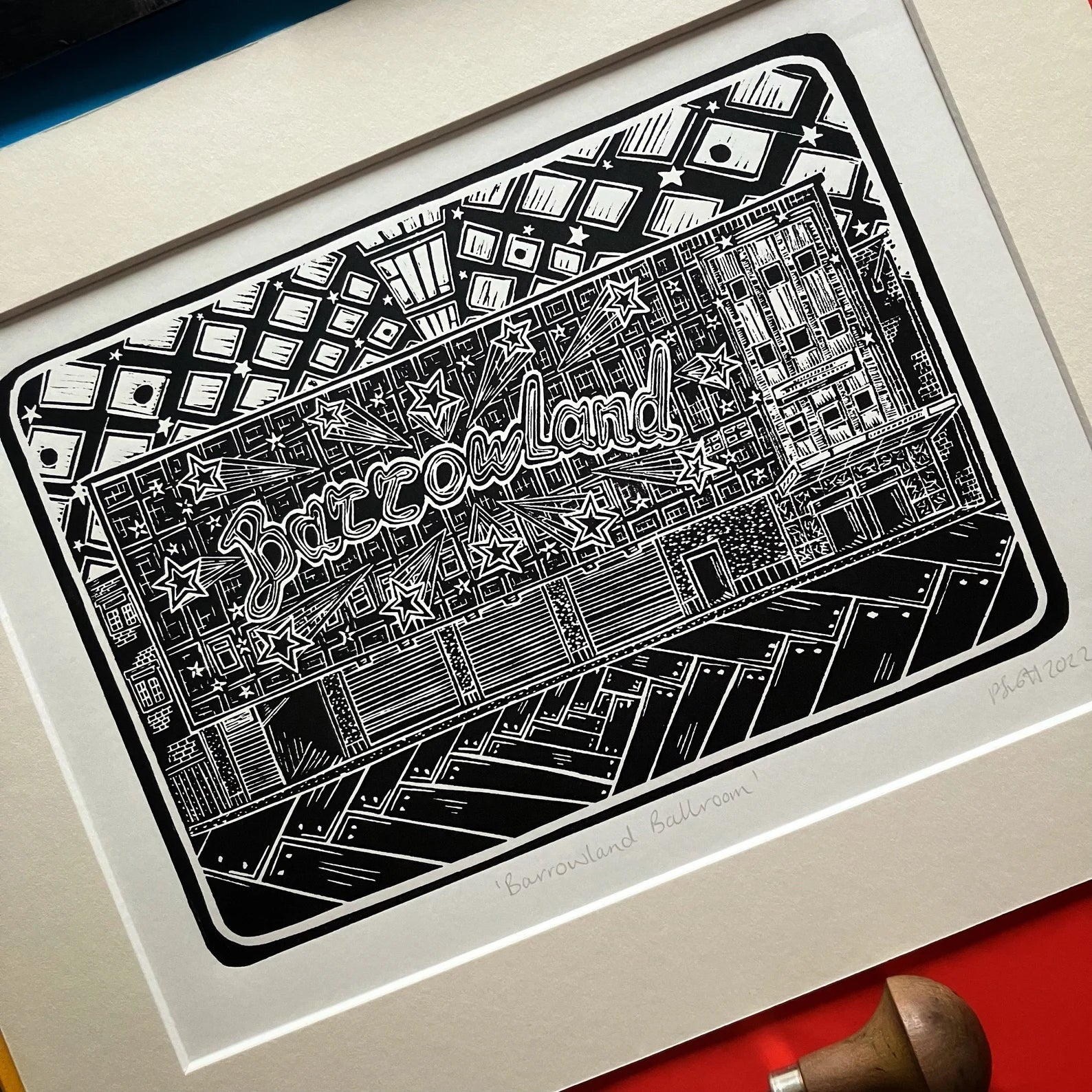 An original black and white linocut print of the iconic Barrowland Ballroom in Glasgow, mounted on antique white card.