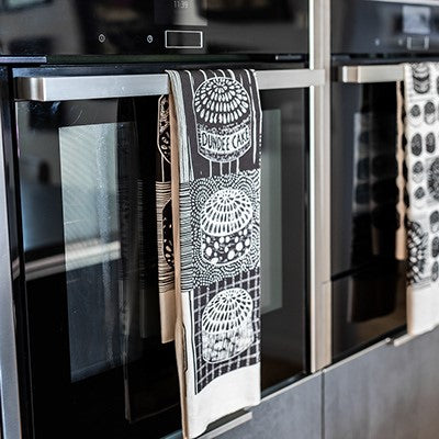 Dundee Delights tea towel with Dundee Cake illustration by Louise