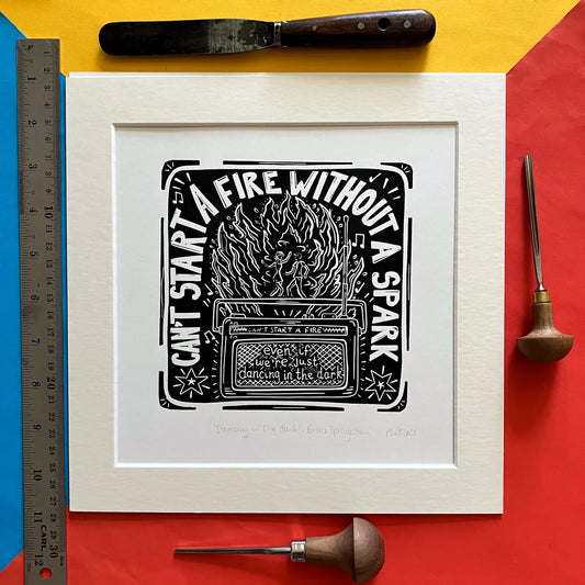 Square black-and-white linocut print inspired by Groove is in the Heart, hand-printed by Pamela Scott, mounted in antique white.