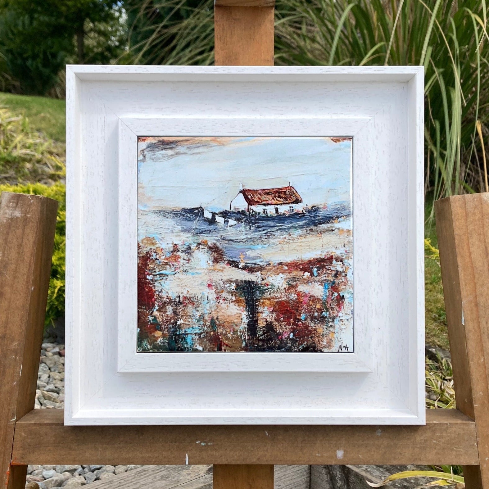 A ceramic tile print of a colourful painting titled 'Easter Cottage', showing a small house nestled in the Scottish Highlands, available mounted on natural slate or framed.