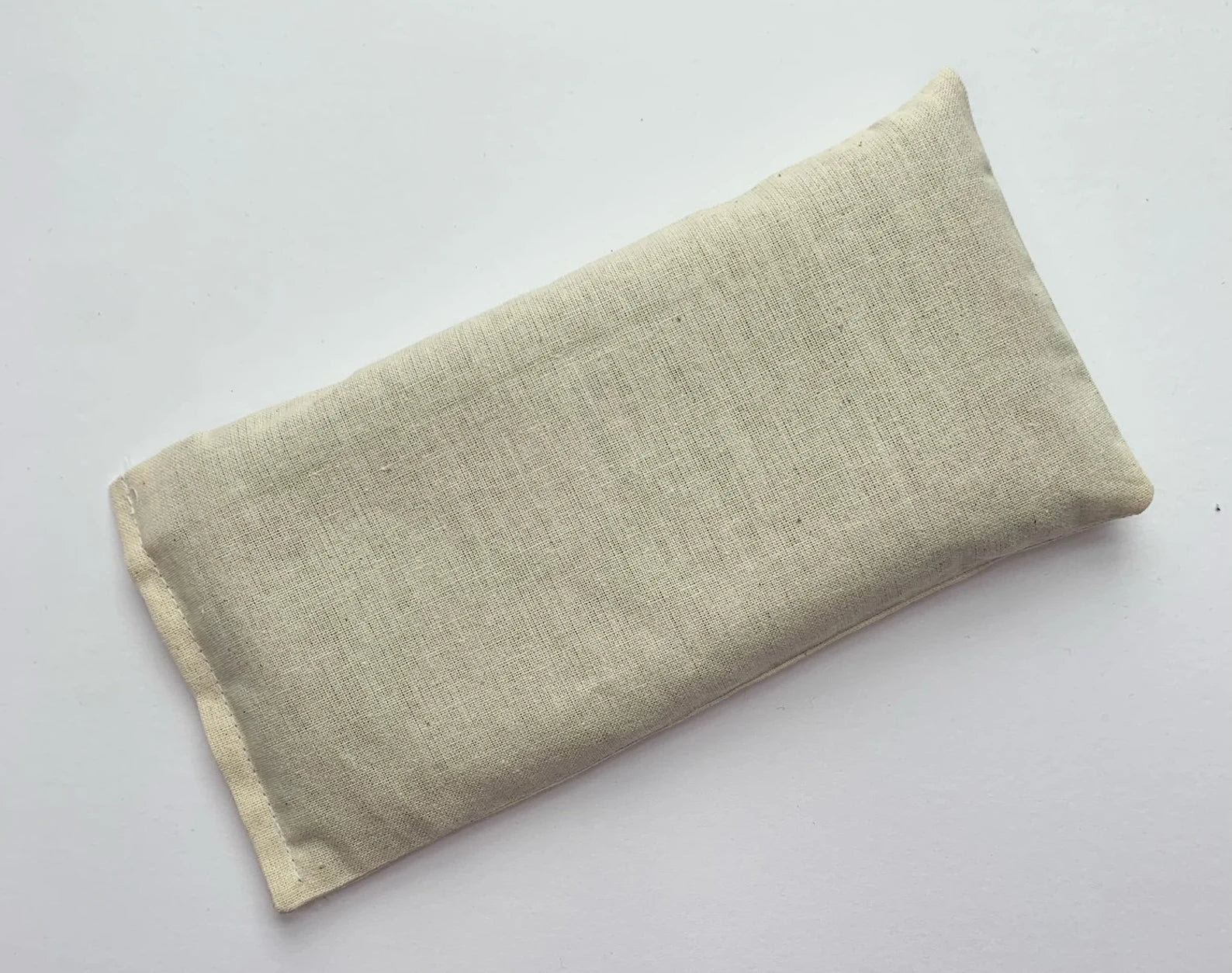 Handmade weighted lavender eye pillow with removable cotton cover, filled with organic flaxseed and dried lavender, perfect for relaxation