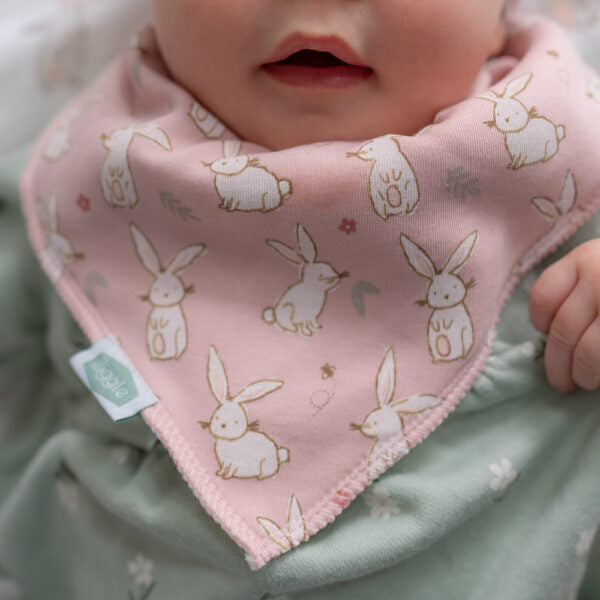 Soft pink baby bandana bib with bunny print, absorbent fleece backing and adjustable poppers