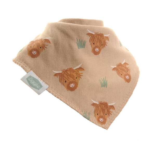 A unisex, beige, soft cotton and fleece bandana dribble bib with illustrations of Highland cows, designed to be worn around the neck.