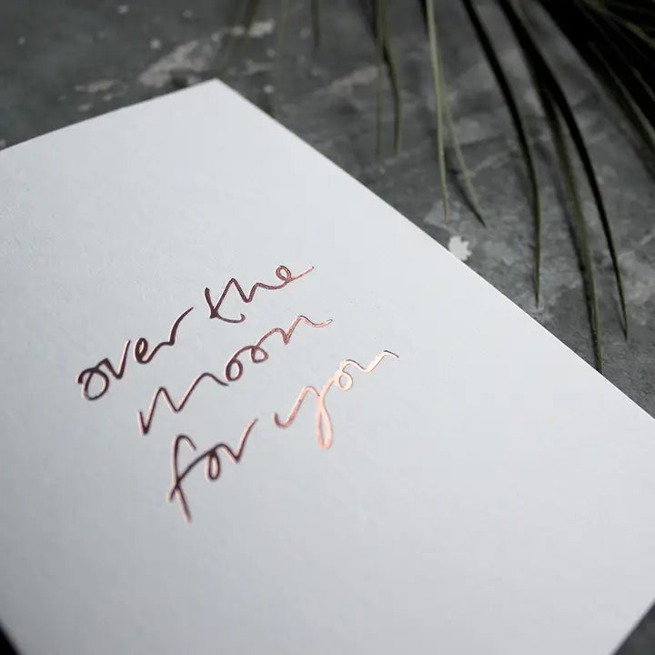 Over The Moon For You A6 congratulations card with rose gold foil, hand-printed on 360gsm Fedrigoni card