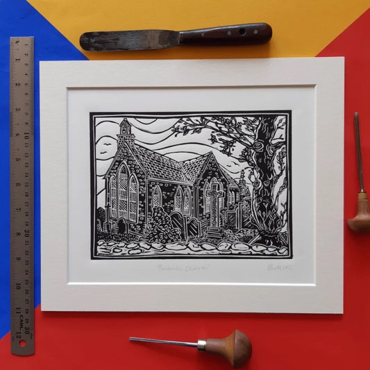 An original black and white linocut print by Pamela Scott depicting the quiet, historic Panbride Church in Carnoustie, mounted on antique white card.