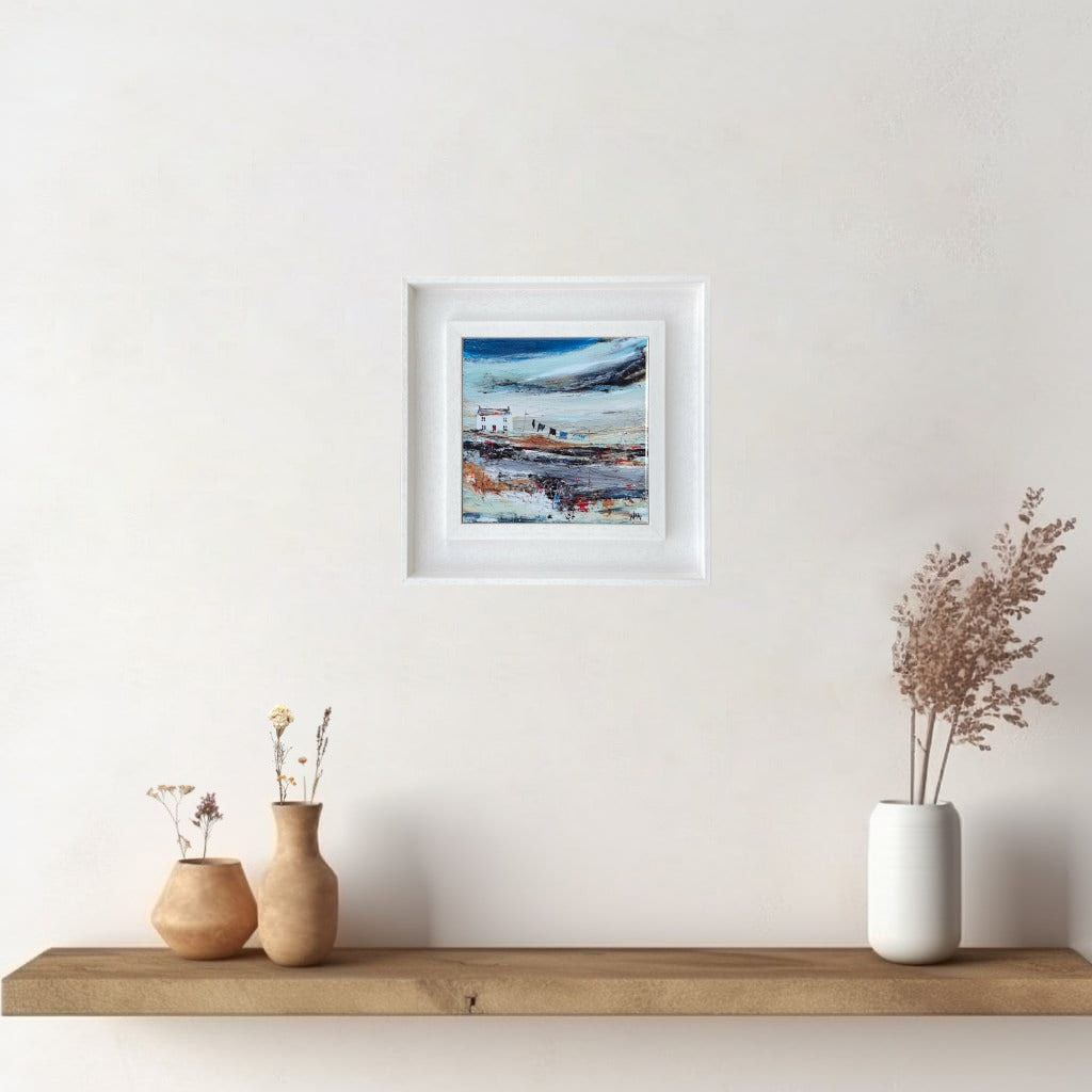 A ceramic tile print of a colourful painting titled 'Road to the Shee', showing a small house nestled in the Scottish Highlands, available mounted on natural slate or framed.
