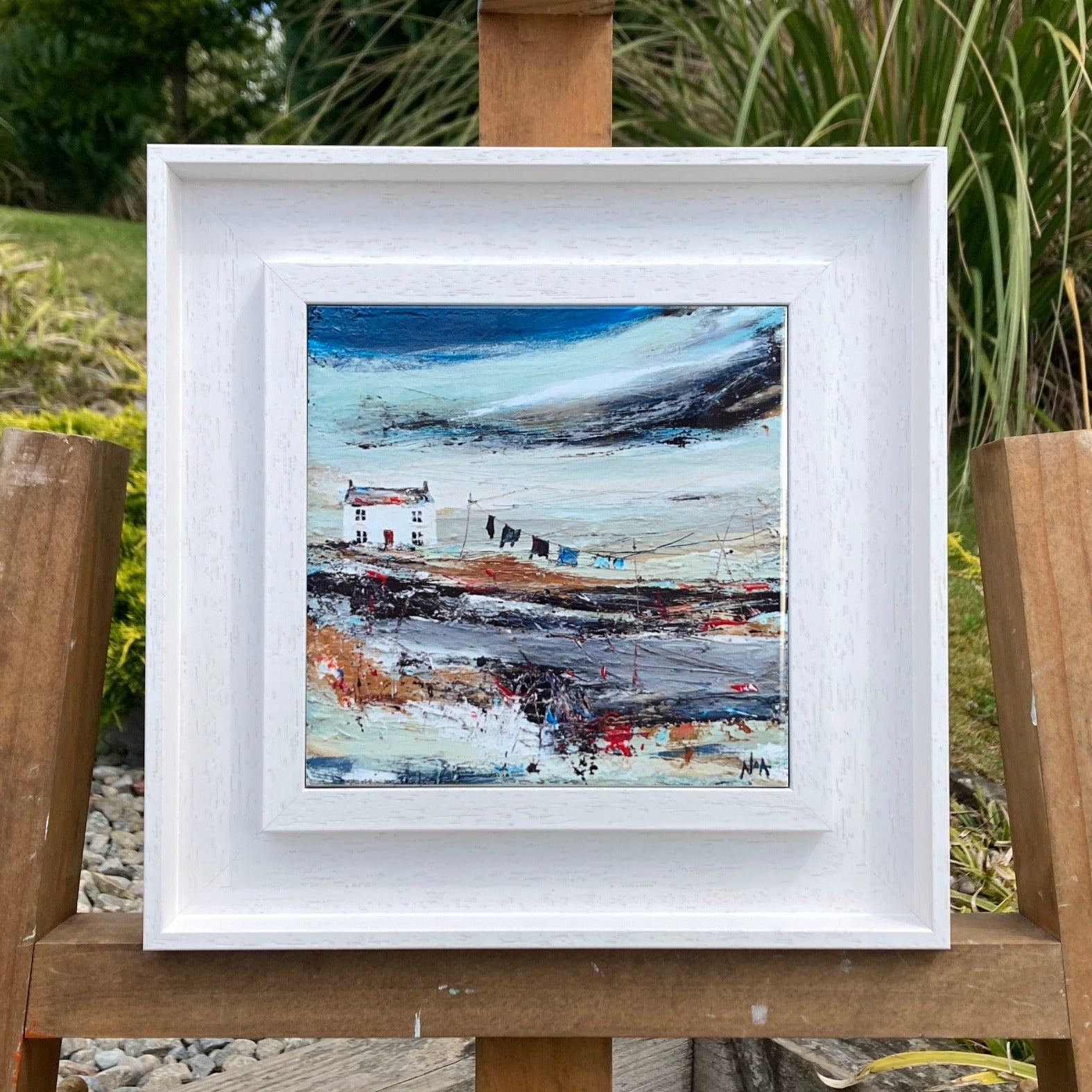 A ceramic tile print of a colourful painting titled 'Road to the Shee', showing a small house nestled in the Scottish Highlands, available mounted on natural slate or framed.