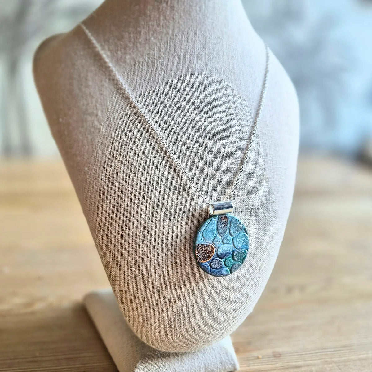 Sefara Jewellery coastal seascape pendant necklaces in circle and square designs, featuring unique 30mm pendants with gold leaf details on silver-plated chains.