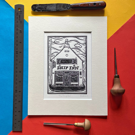 Black-and-white linocut of The Ship Inn pub in Broughty Ferry, Dundee, hand-printed by Pamela Scott, mounted in antique white.