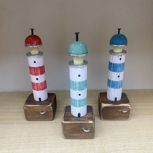 Handcrafted wooden lighthouse ornaments with rustic metal and rope details in Blue, Green, or Red