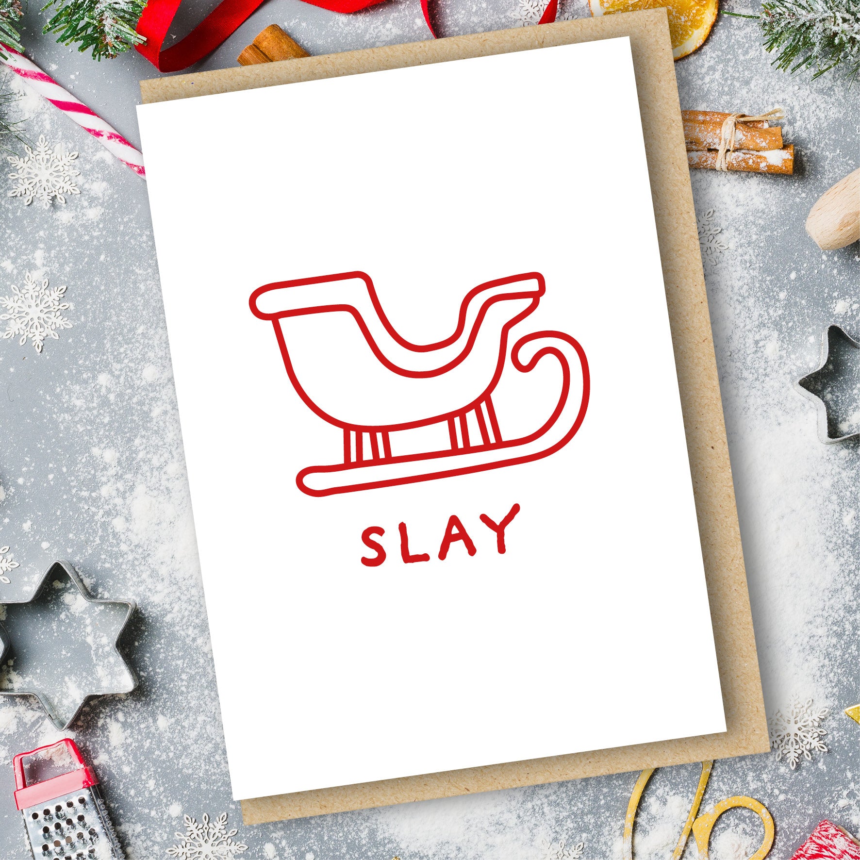An A6 vertically folded greeting card with the bold, humorous and trendy Christmas message "Slay Card" in a hand-designed typography style.