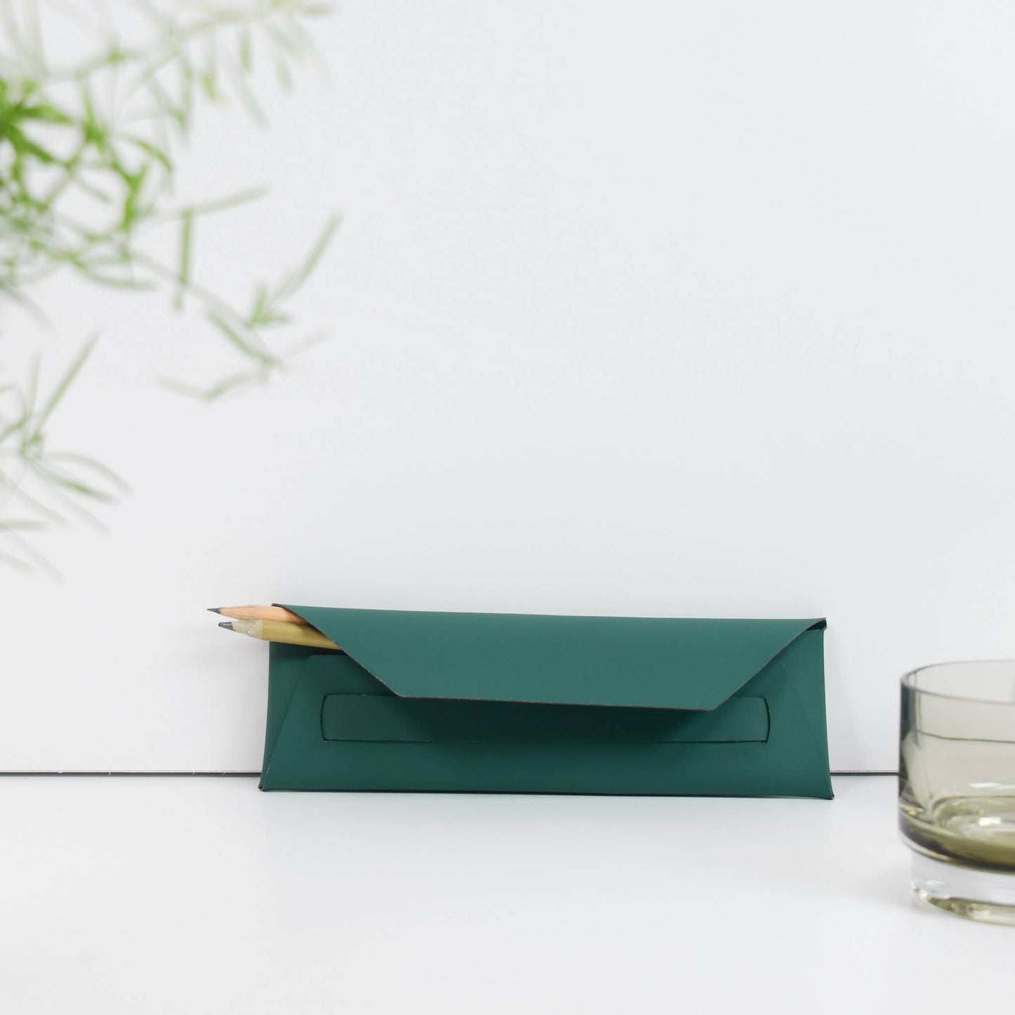 Handmade recycled leather pencil pouch debossed with ETHOS design, in rich green, stylish and sustainable accessory