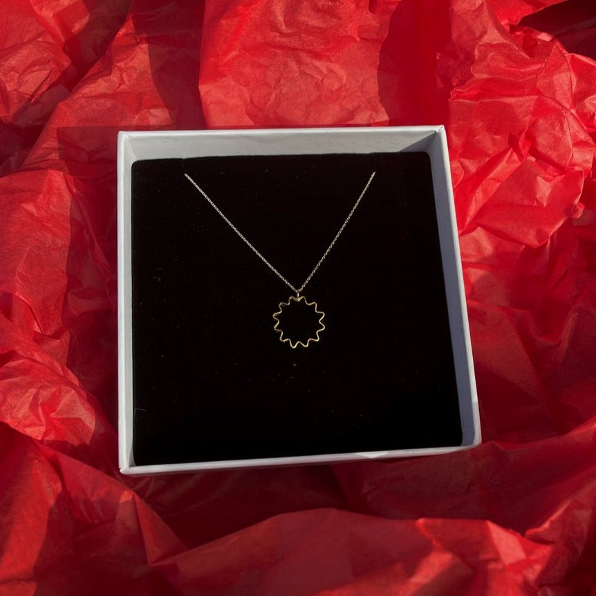 Mini ondulée pendant necklace in recycled sterling silver with silver chain, handmade by Olivia Taylor in Glasgow gift boxed and sitting on red tissue paper