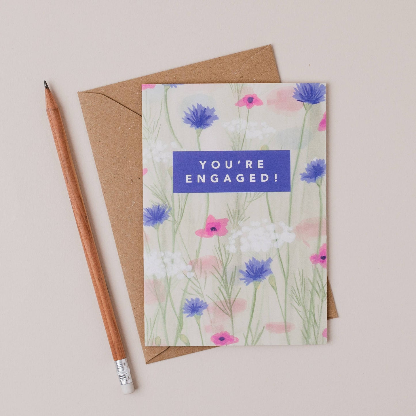 Luxury A6 engagement card with 'you're engaged!' text and blue, white, pink flower illustration, blank inside, printed on 350gsm UK card