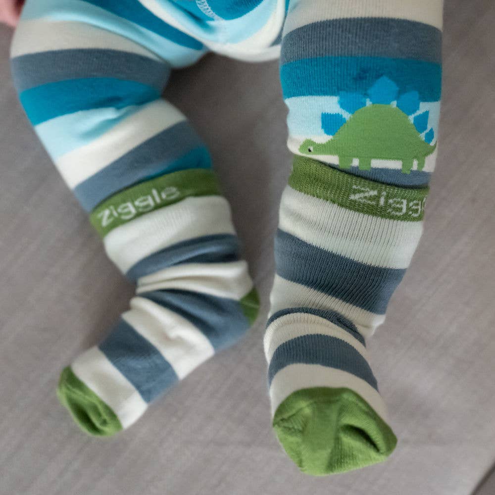 Baby feet wearing cotton baby socks with dinosaur design, anti-slip soles and ribbed cuffs