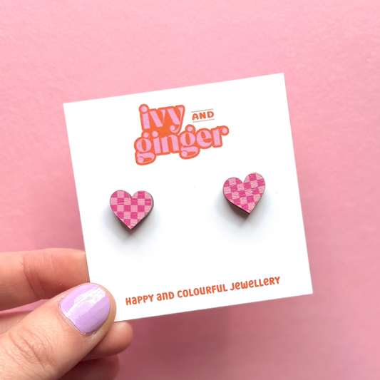 Pink checkerboard heart-shaped wooden stud earrings, FSC wood, surgical steel posts, 13mm, lightweight, colourful, gift-ready.
