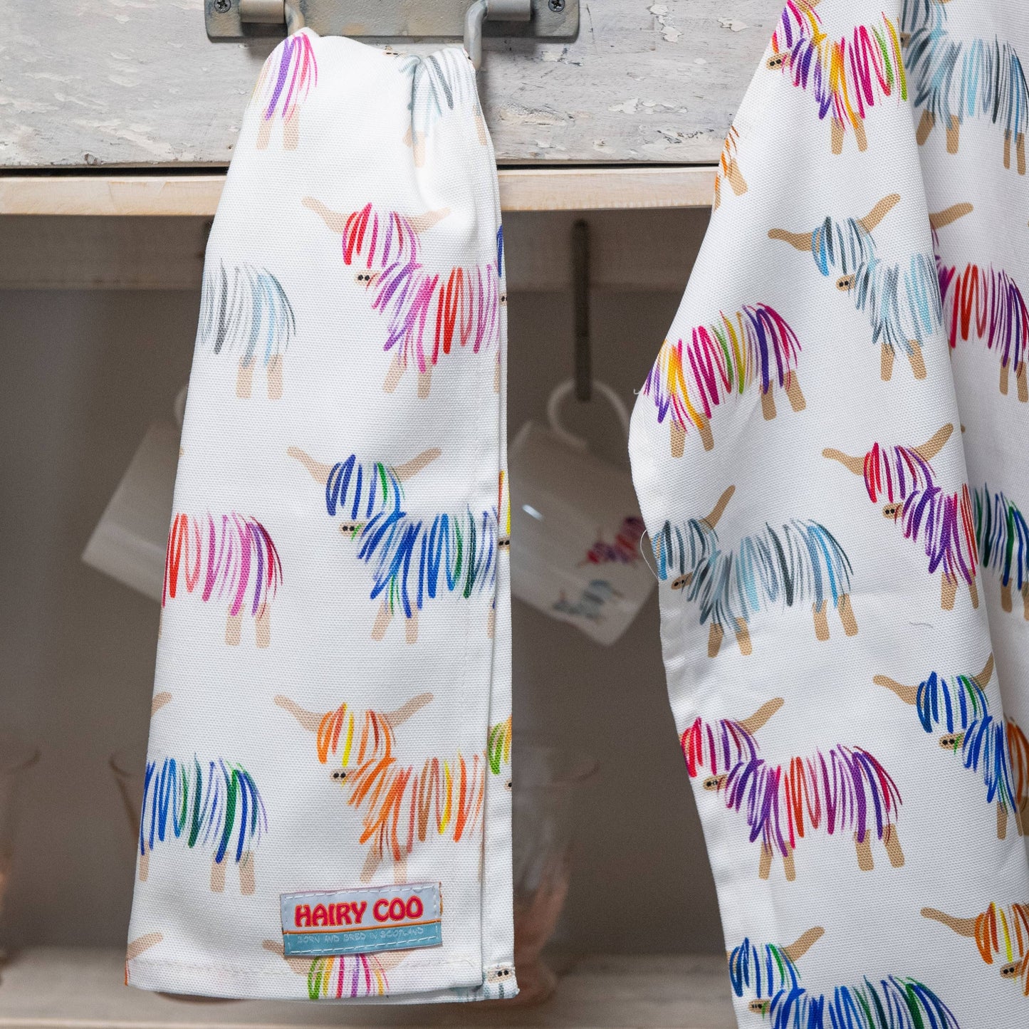 100% cotton Hairy Coo tea towel featuring a bright highland cow design