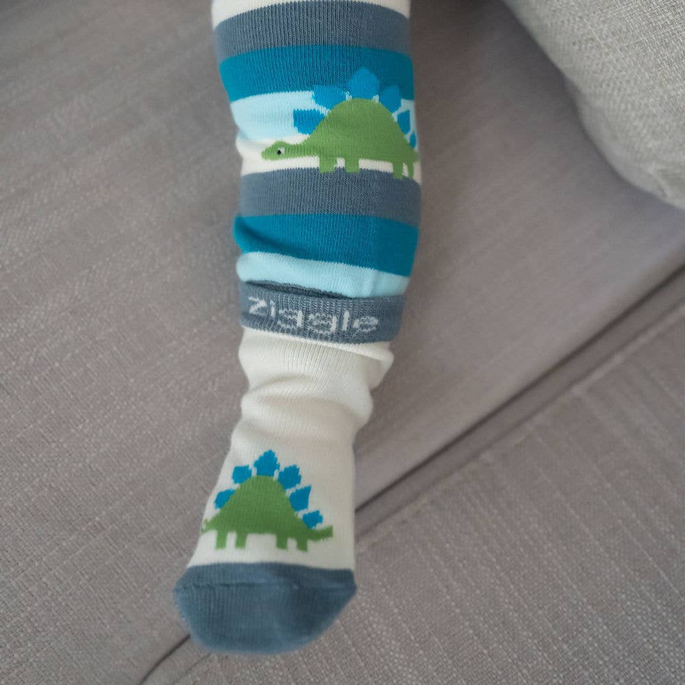 Baby feet wearing cotton baby socks with dinosaur design, anti-slip soles and ribbed cuffs