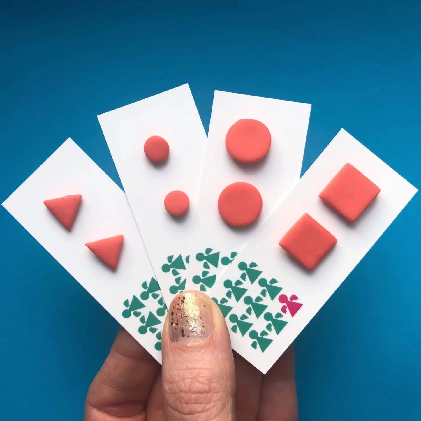 CORAL PINK TRIANGLE STUDS