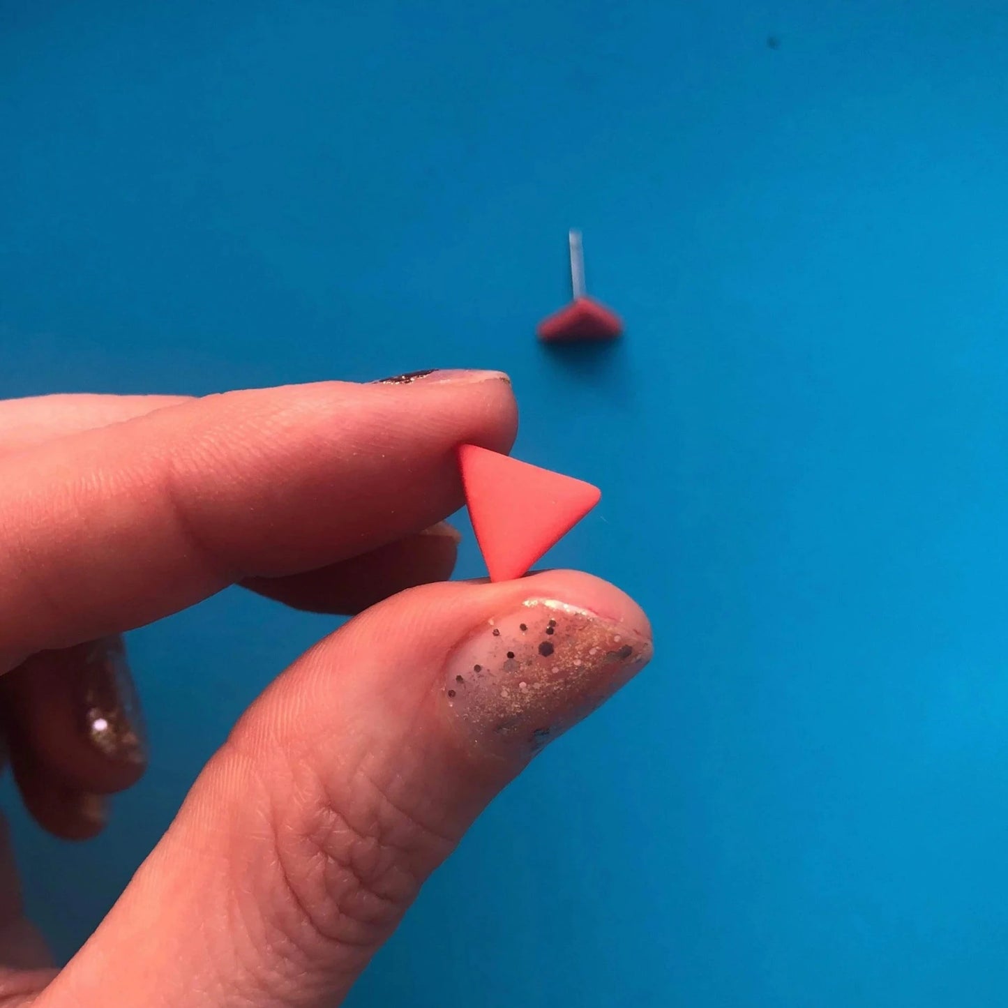 CORAL PINK TRIANGLE STUDS