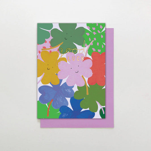 Good Luck card with happy clovers, gold foil detail and lilac envelope