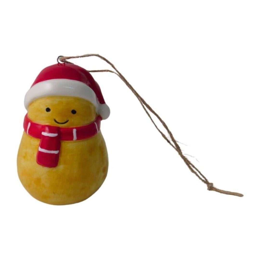 A small, novelty ceramic potato decoration with a happy face, wearing a red Christmas hat and matching scarf, ready to be hung on a tree.