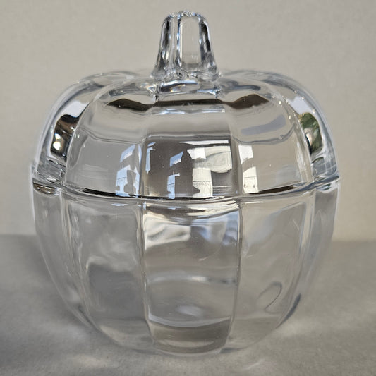 Glass pumpkin-shaped jar, ideal for storage or autumn decoration.