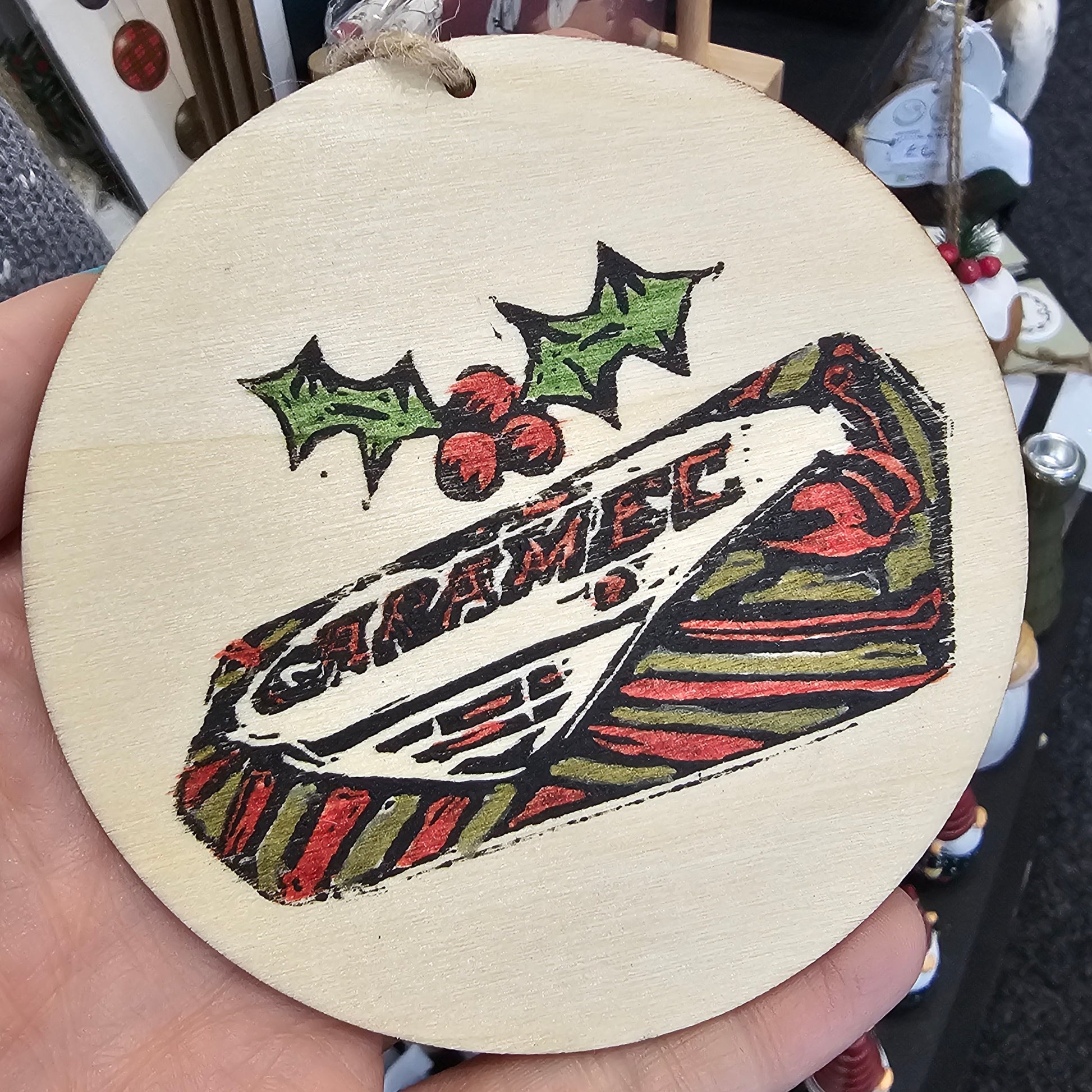 Small handprinted wooden Christmas tree decorations featuring caramel wafer design