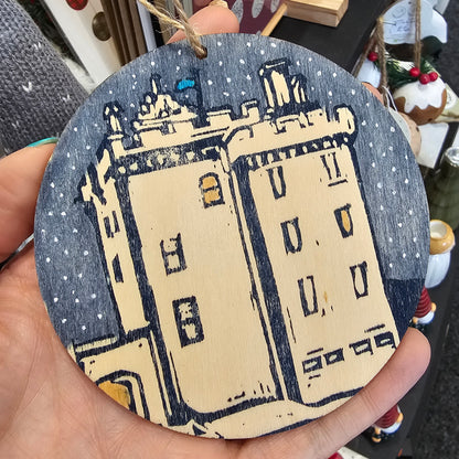 Small handprinted wooden Christmas tree decorations featuring Broughty Ferry castle design in blue