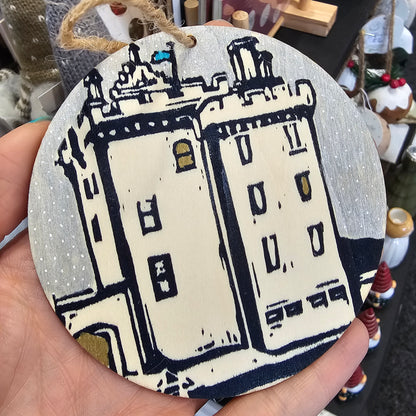 Small handprinted wooden Christmas tree decorations featuring Broughty Ferry castle design in silver