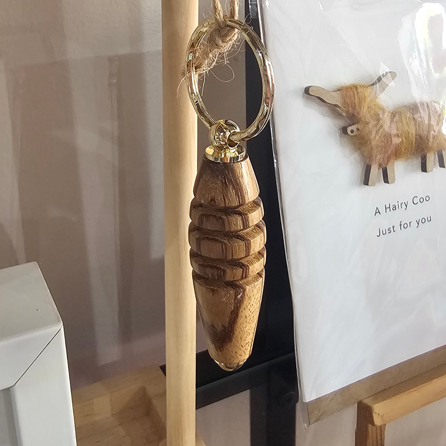 Hand turned wooden keyring with gold plated hardware and unique grain