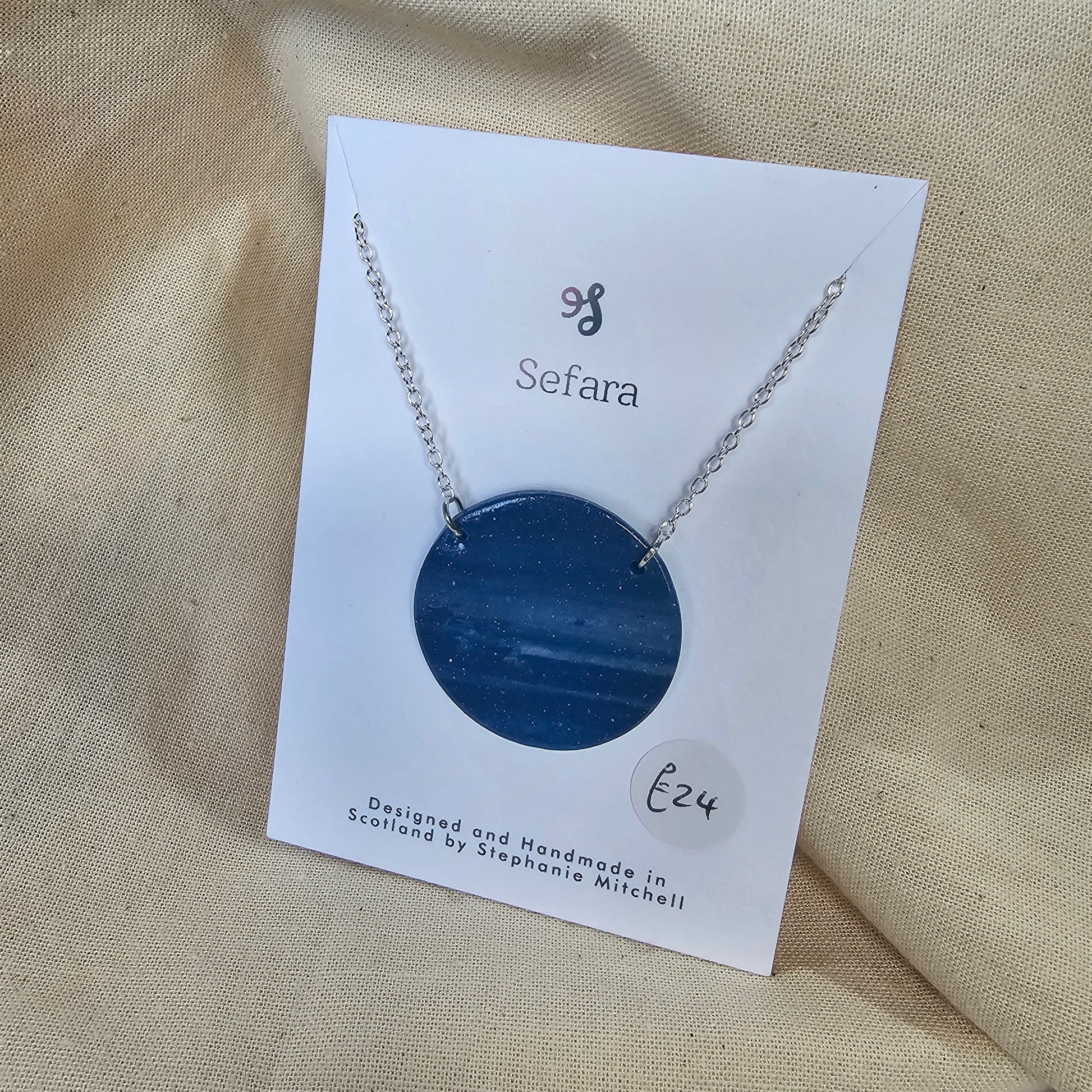 Large handmade navy blue polymer clay pendant on 18-inch silver chain by Sefara Jewellery. 