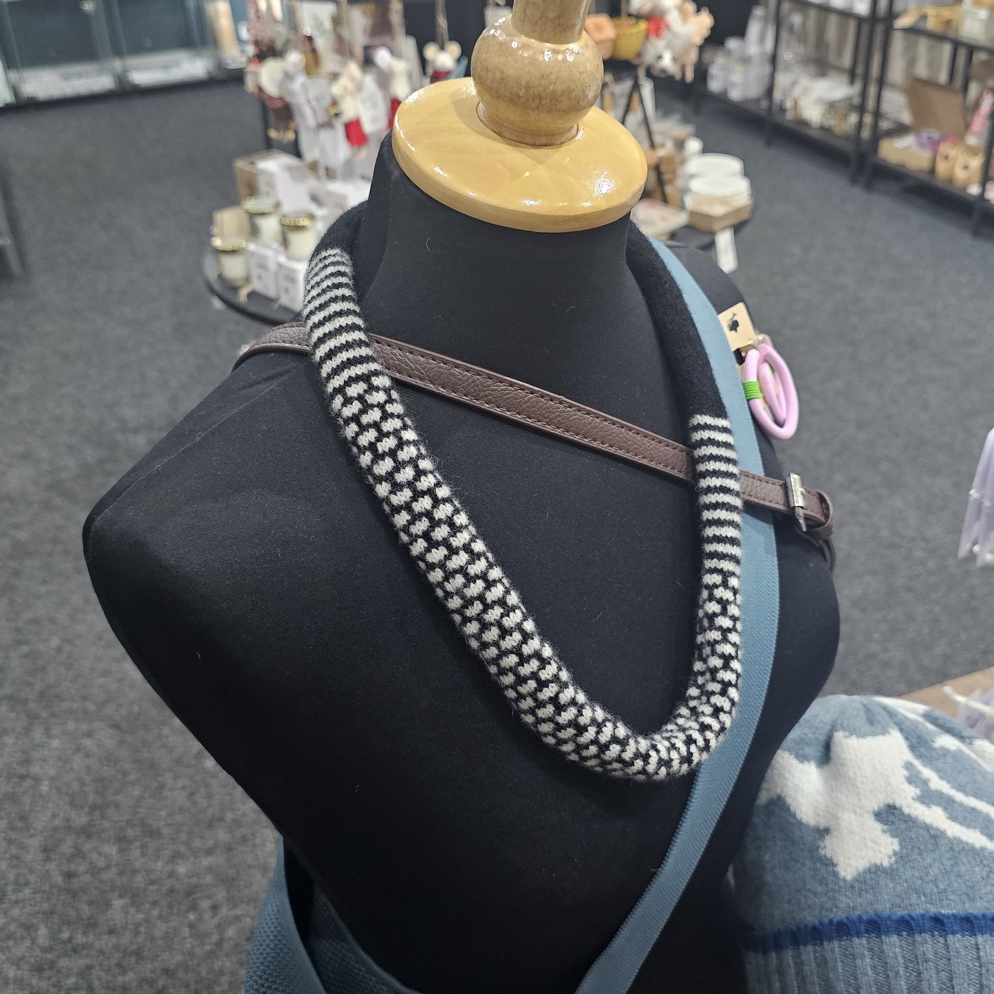 Handmade Scottish lambswool knitted necklace in soft looped design, shown on mannequin highlighting texture and craftsmanship.