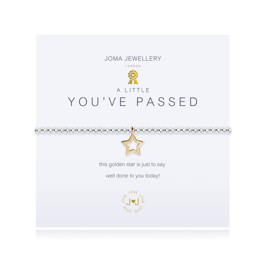 A silver bracelet with a gold-plated star charm, presented on a card that reads 'JOMA JEWELLERY A LITTLE YOU'VE PASSED', indicating a celebration of an achievement.