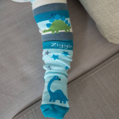 Baby feet wearing cotton baby socks with dinosaur design, anti-slip soles and ribbed cuffs