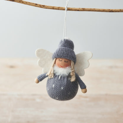 Knitted fabric angel decoration with spotty body, white wings and a woolly hat.